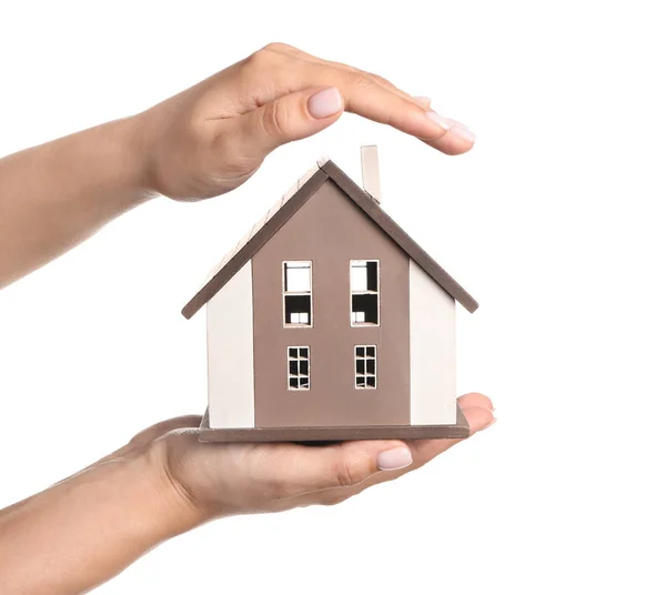 Female hands with figure of house on white background. Mortgage concept — Stock Photo, Image