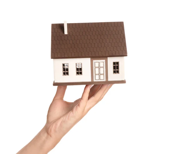 Mano femenina con figura de casa sobre fondo blanco. Concepto hipotecario —  Fotos de Stock