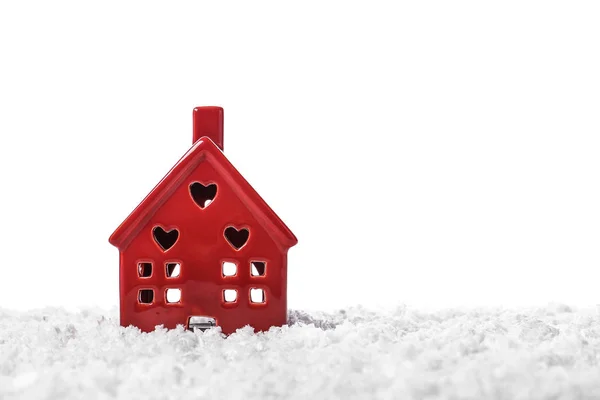 Figure of house on snow against white background — Stock Photo, Image