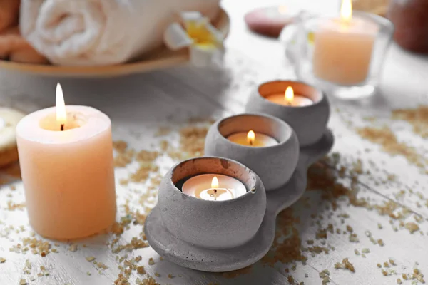 Beautiful burning candles and sea salt for spa on table — Stock Photo, Image