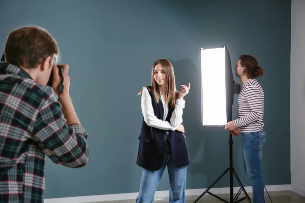 Professional photographer working with model in studio