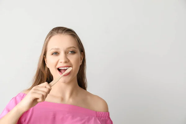 Happy woman with toothbrush on light background — Stock Photo, Image