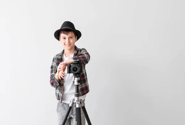 Cute little photographer on white background