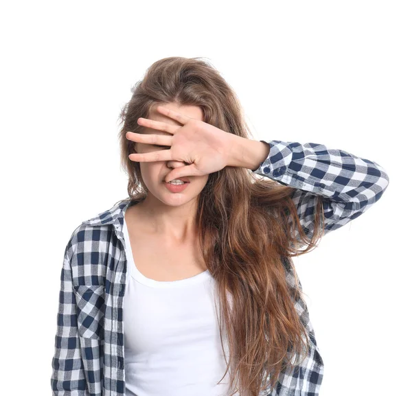 Young woman covering her eyes on white background — Stock Photo, Image