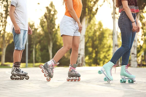 Teenagers on roller skates outdoors — Stock Photo, Image