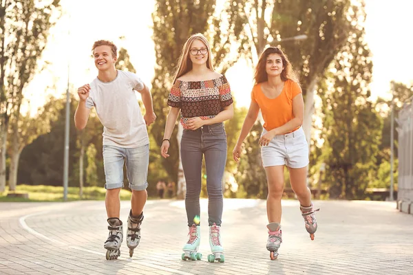 Teenagers on roller skates outdoors — Stock Photo, Image