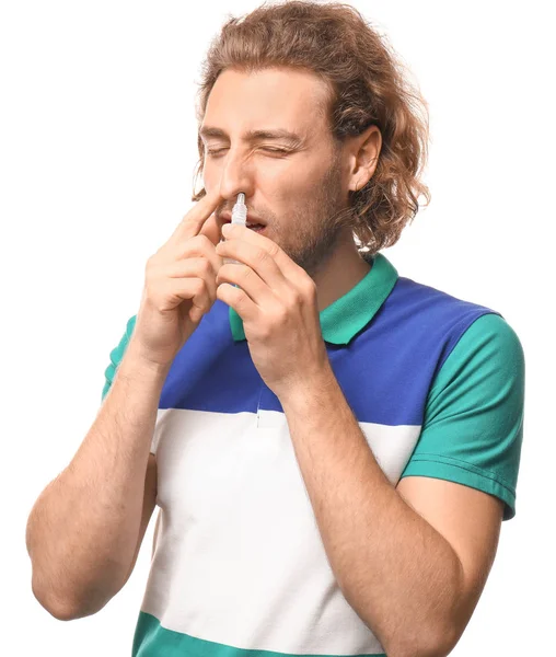 Young man with nasal drops on white background — Stock Photo, Image