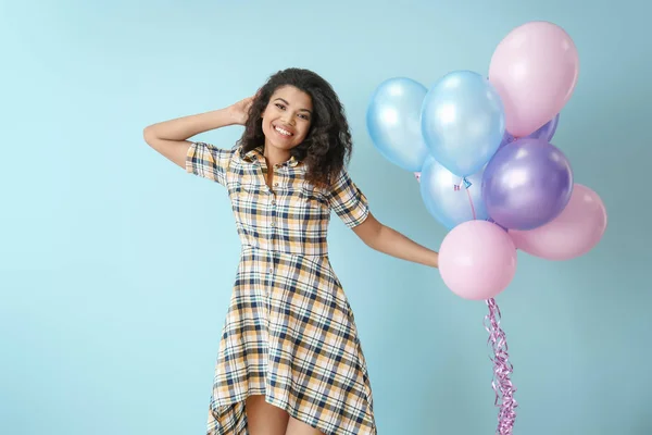 Portret van Happy African-Amerikaanse vrouw met lucht ballonnen op kleur achtergrond — Stockfoto