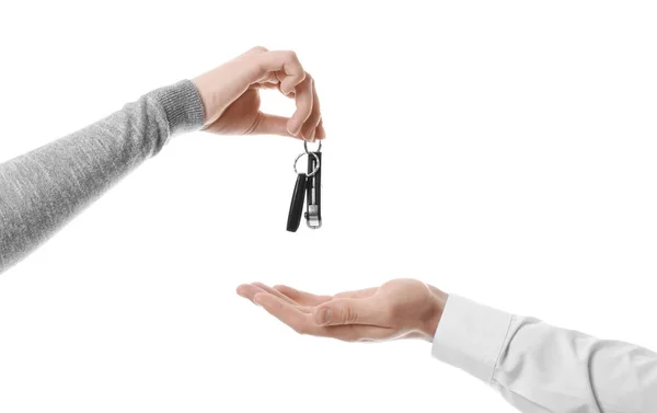 Saleswoman giving car keys to man on white background — Stock Photo, Image