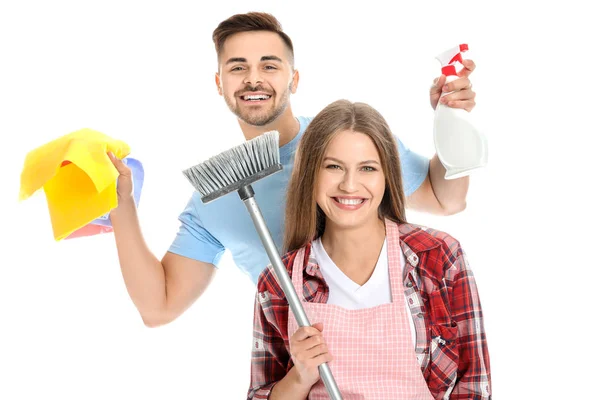 Happy young couple with cleaning supplies on white background — Stock Photo, Image