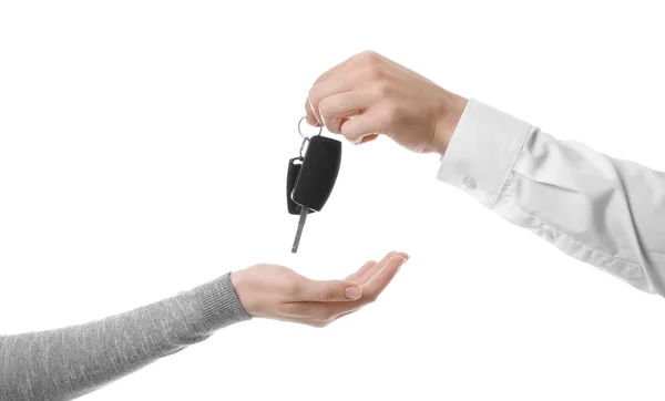 Salesman giving car keys to woman on white background — Stock Photo, Image