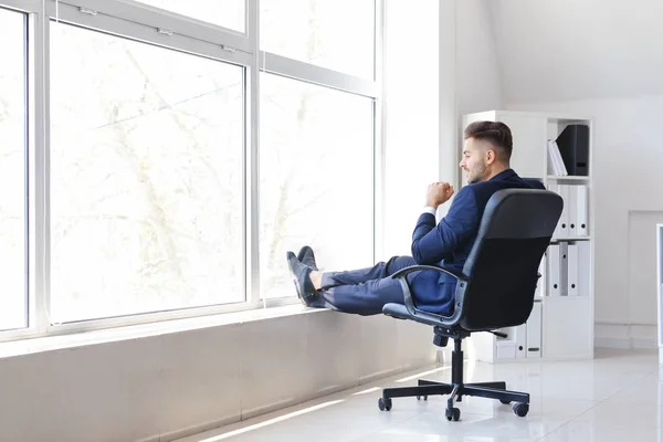 Carefree businessman having break in office — Stock Photo, Image