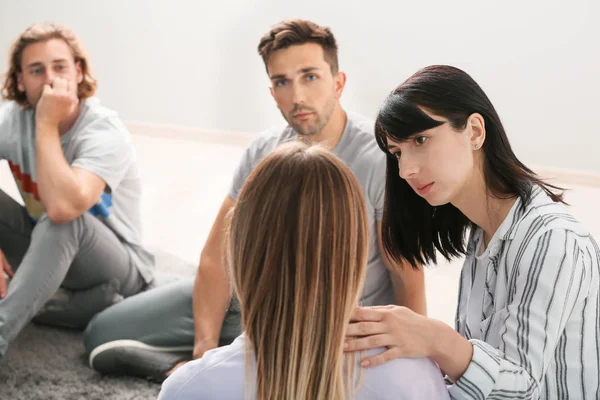 People calming woman at group therapy session — Stock Photo, Image