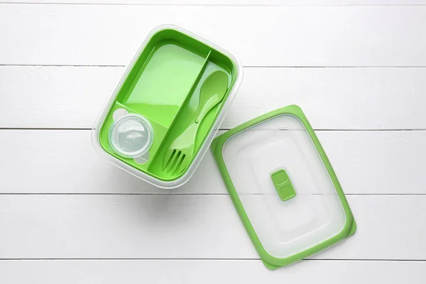 Lunchbox aus Kunststoff auf weißem Holzhintergrund — Stockfoto