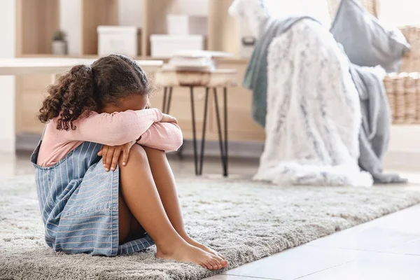 Crying little African-American girl at home — Stock Photo, Image