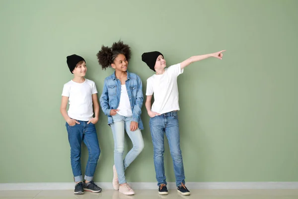 Stylish children in jeans clothes near color wall — Stock Photo, Image