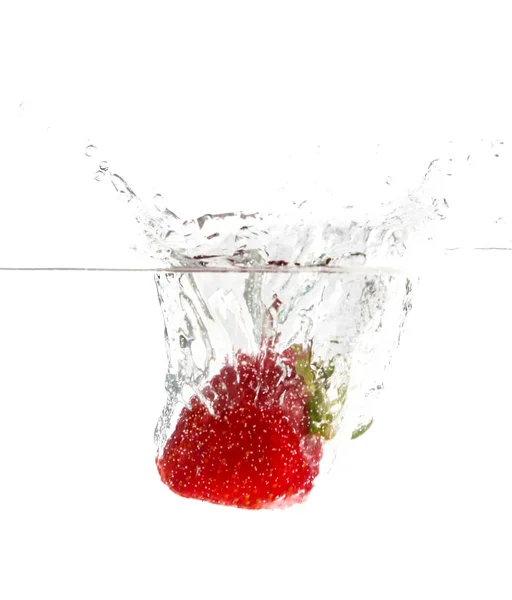 Caída de fresa dulce en agua sobre fondo blanco — Foto de Stock