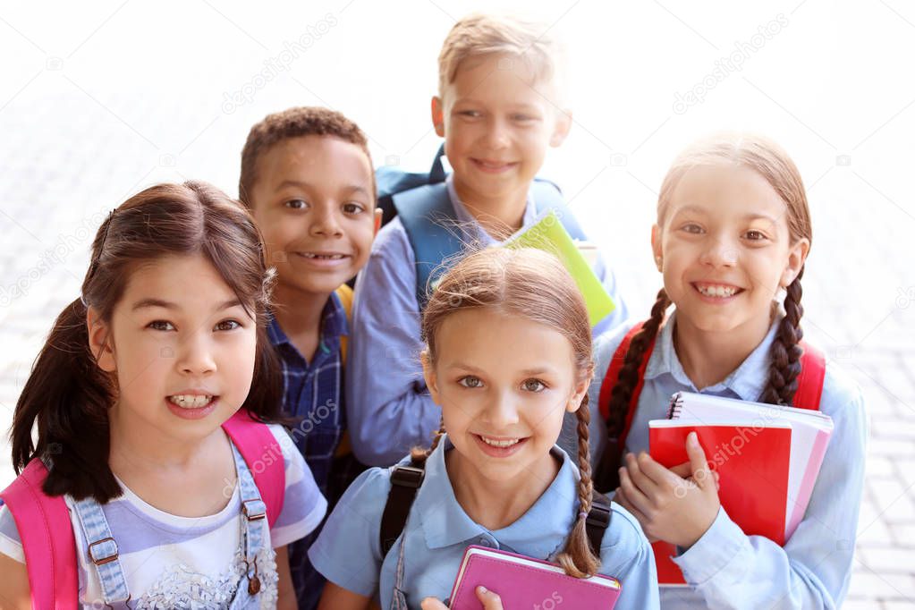 Group of cute little pupils outdoors