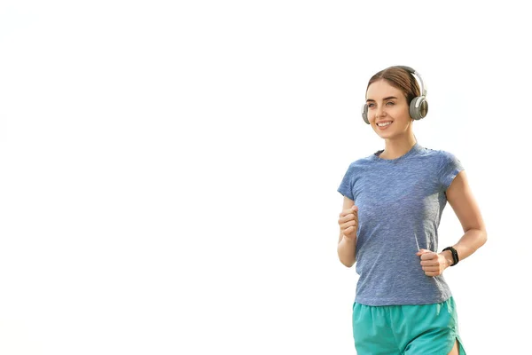 Sporty running young woman on white background — Stock Photo, Image