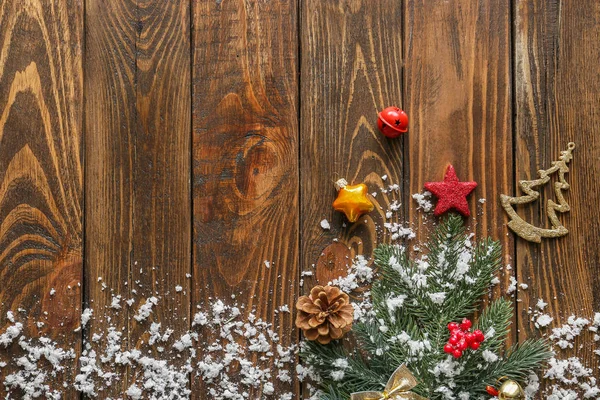 Christmas tree branch, snow and decor on wooden background — Stock Photo, Image