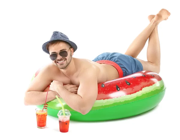 Happy young man with inflatable ring and cocktails on white background — Stock Photo, Image