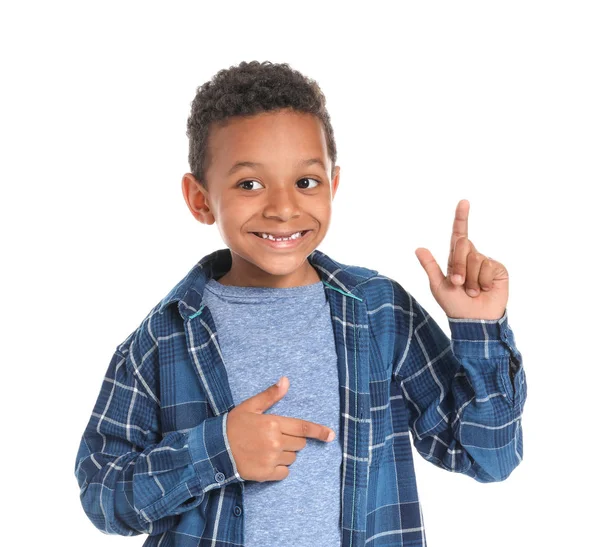 Cute African-American boy pointing at something on white background — Stock Photo, Image