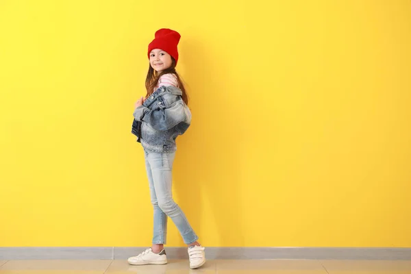 Stylish girl in jeans clothes near color wall — Stock Photo, Image