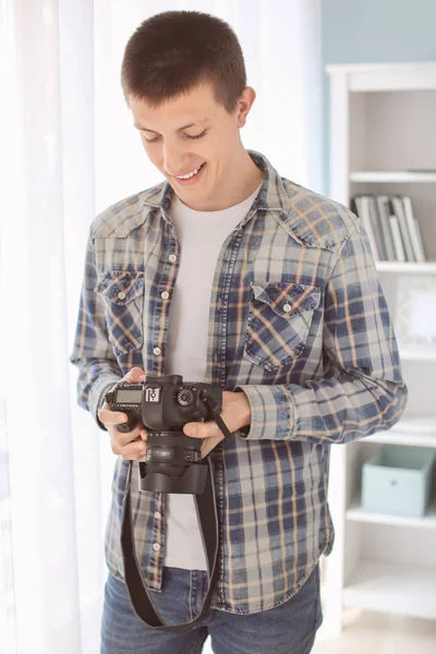 Nastoletni chłopiec z aparatem fotograficznym w domu — Zdjęcie stockowe