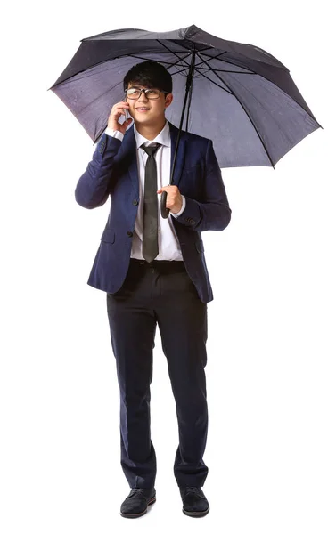 Handsome Asian businessman with umbrella on white background — Stock Photo, Image