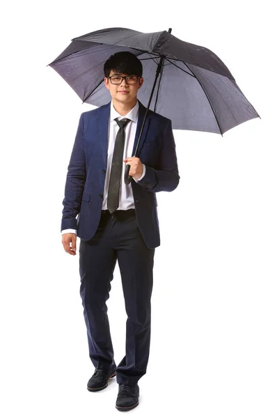 Handsome Asian businessman with umbrella on white background — Stock Photo, Image
