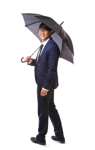 Handsome Asian businessman with umbrella on white background — Stock Photo, Image