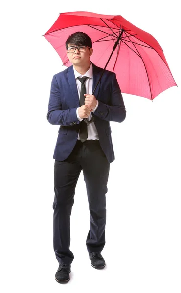 Handsome Asian businessman with umbrella on white background — Stock Photo, Image