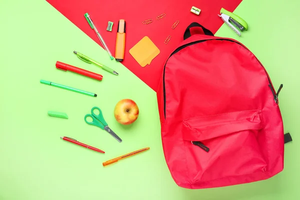 School backpack and stationery on color background — Stock Photo, Image