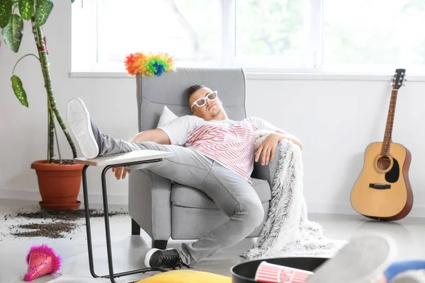 Young man sleeping after party at home