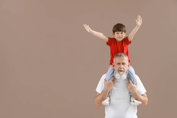 Divertido niño con abuelo en el fondo de color —  Fotos de Stock