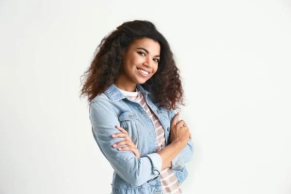 Portrait of cute African-American woman on light background — Stock Photo, Image