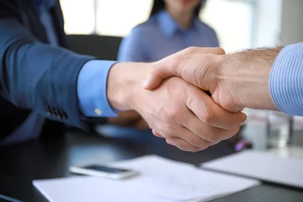 Businessmen shaking hands during meeting in office, closeup — Stock Photo, Image