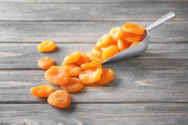 Ahşap arka plan üzerinde kuru kayısı ile Kepçe