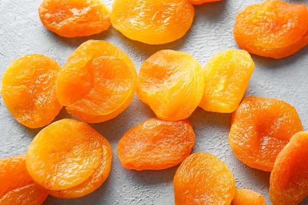 Tasty dried apricots on light background — Stock Photo, Image