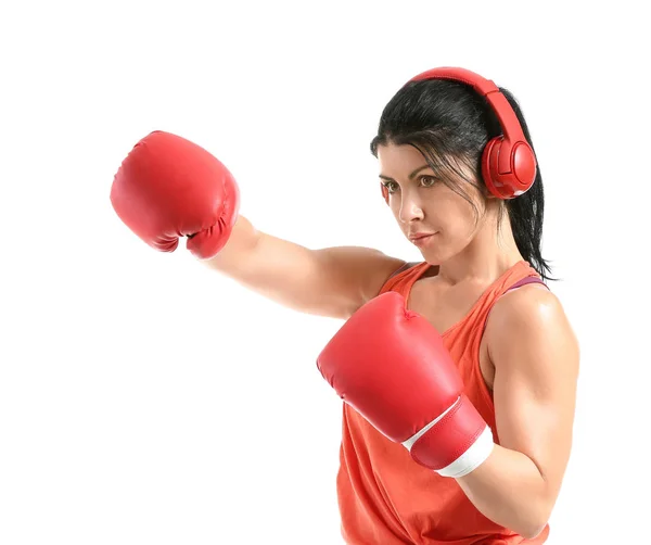 Sporty female boxer with headphones on white background — Stock Photo, Image