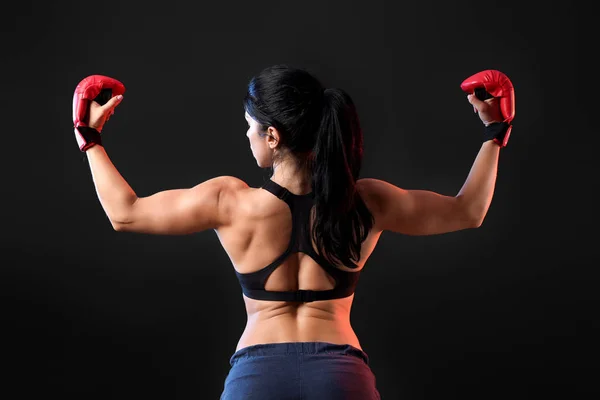 Sporty female boxer on dark background — Stock Photo, Image