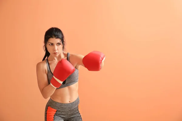 Sporty female boxer on color background — Stock Photo, Image
