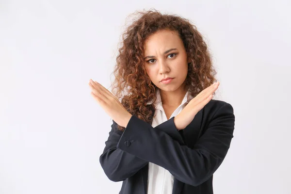 African-American businesswoman rejecting something on white background — Stock Photo, Image