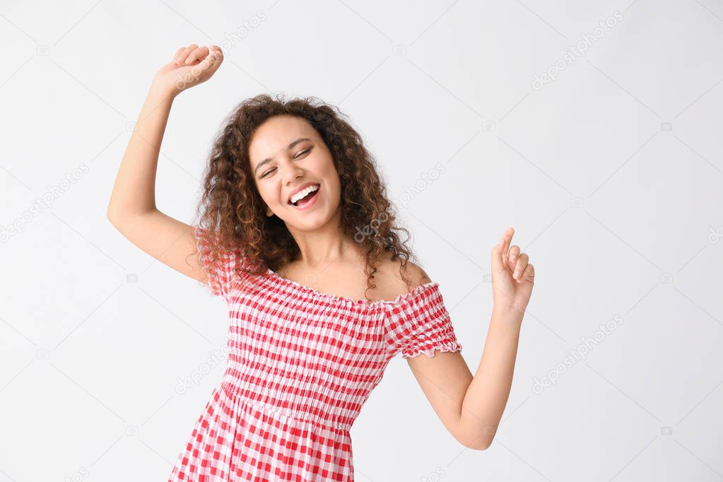 Dancing African-American woman on white background