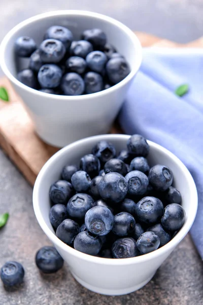 Bowls with ripe blueberry on table — Stock Photo, Image