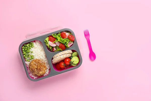 School lunch box with tasty food on color background