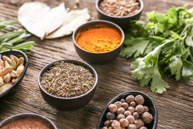 Ahşap arka planda farklı otlar ve baharatlar