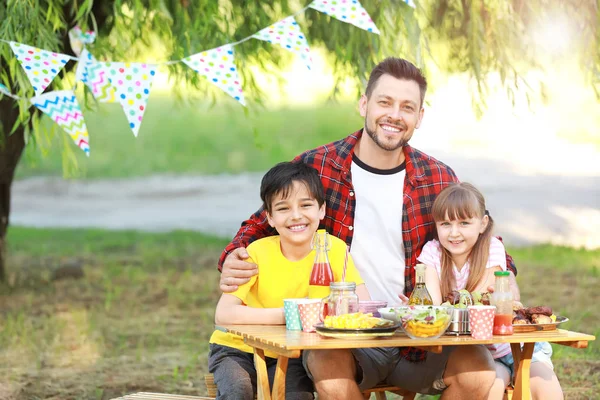 Happy family having picnic on summer day — Stock Photo, Image