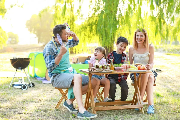 Happy family having picnic on summer day — Stock Photo, Image