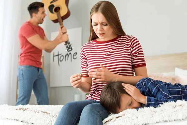 Woman calming little son during family quarrel — Stock Photo, Image